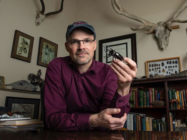 Professor Doug Emlen holds a beetle