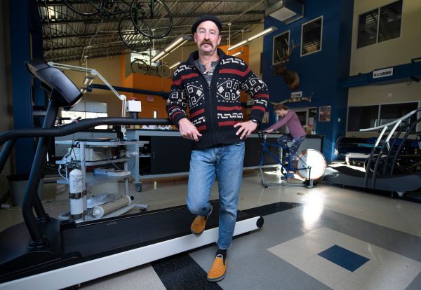 UM Researcher Brent Ruby leans against a treadmill in his lab