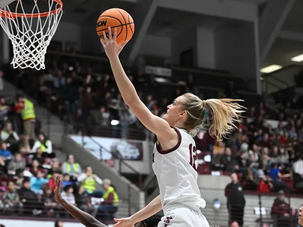 A Lady Griz player goes to the net during a game in Dahlberg Arena