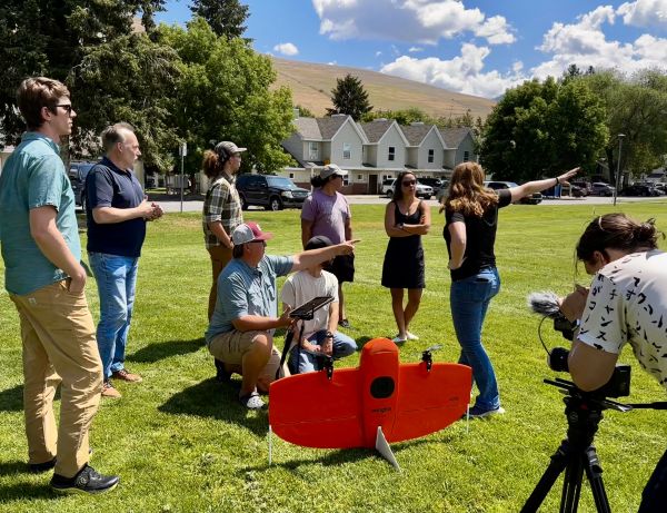 people clustered around a wingtra drone