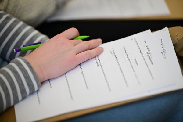 close up of a hand writing on an exam
