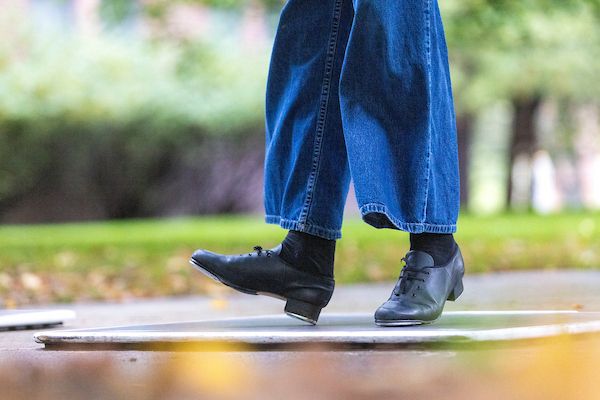 The lower legs and feet of a tap dancer.