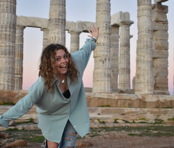 Girl standing in front of monument in Greece