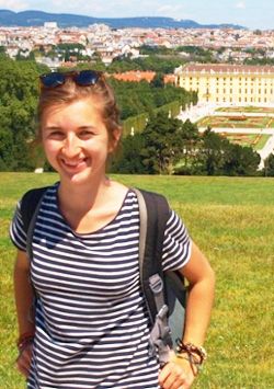 Dr. Diana Diaków standing in front of a view of a city