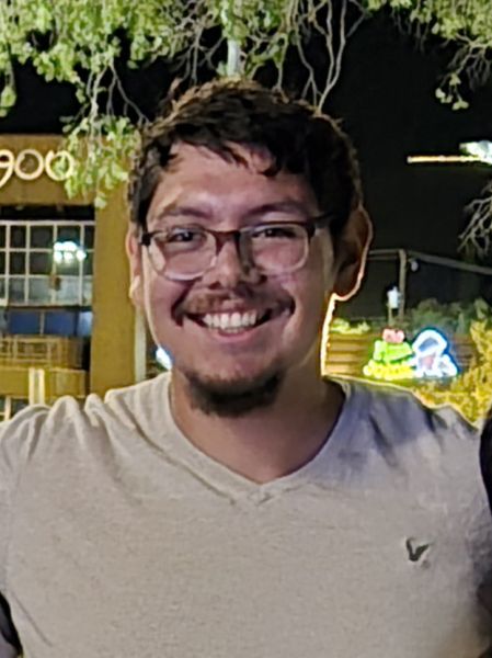 Arturo Jimenez smiling standing outside at nighttime