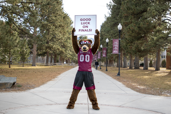 image of Monte holding a "Good luck on finals" sign. 