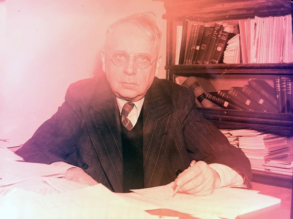 J. B. Speer behind a desk. 1951
