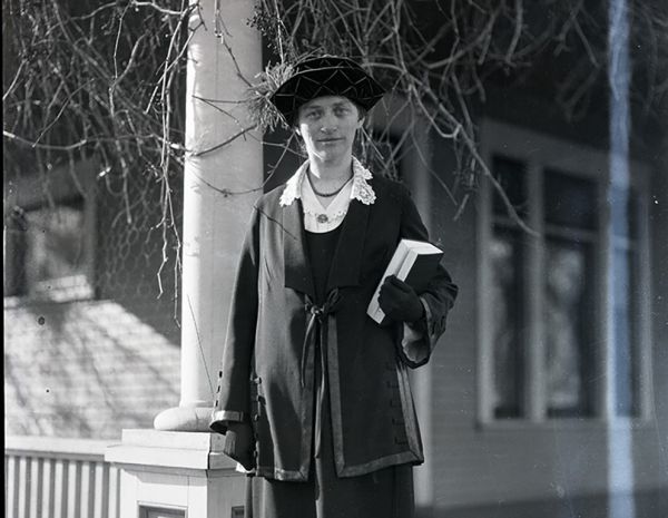 Mary B. Clapp on the porch of a house