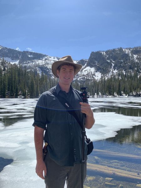 Avery smiling with mountains in the background