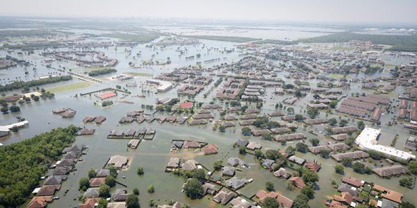 an aerial view of a town underwater with only roof tops showing