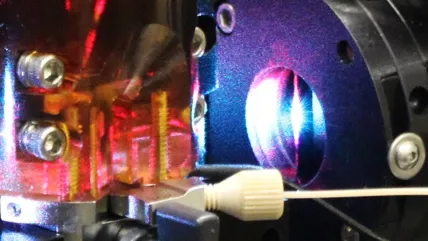 Close-up of a scientific instrument with vibrant reflections, likely related to optics or laser technology