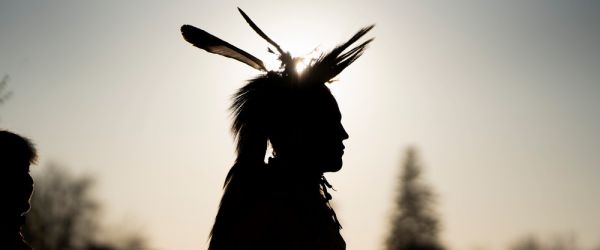 Place holder image- Silhouette of a grass dancer, sun behind them