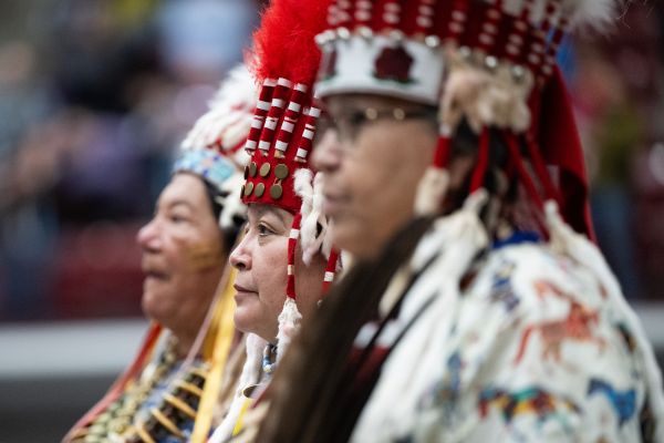 Woman Head dress society member wear their Stand Up head dress at kyiyo powwow