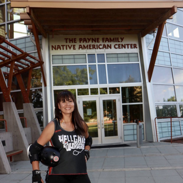 Laura Bird, in front of PFNAC in Roller derby gear/uniform