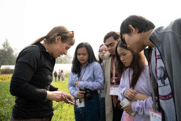 Instructor showing plant roots to students
