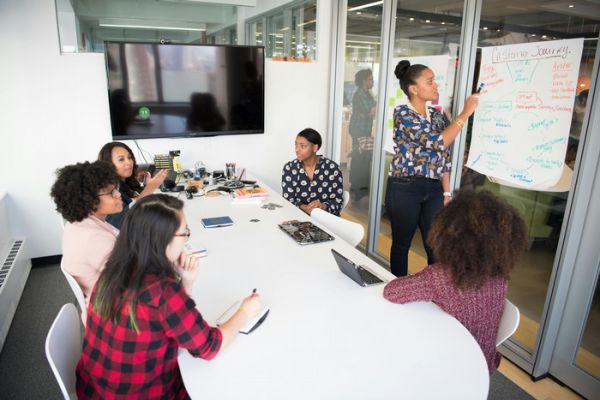 A group of women meeting in a conference room.