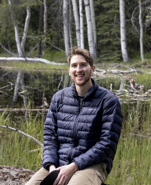 declan smiling outside in a puffy coat