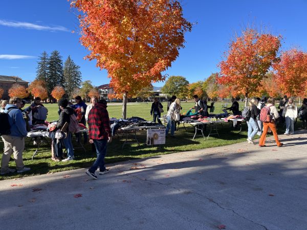 students shop the pop up clothing swap on the oval