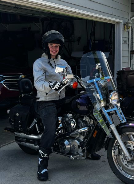 Cameron on a motorcycle smiling. 