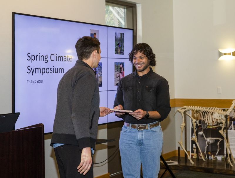 Man presenting award at symposium