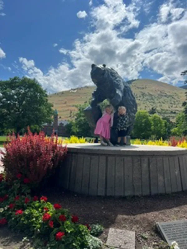 two kids with the statue