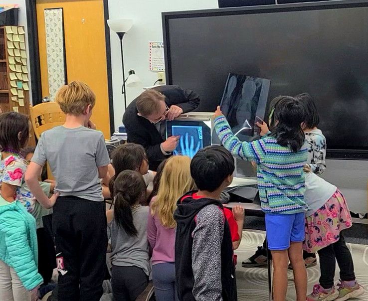 A UM role model walks students through an illuminated X-Ray