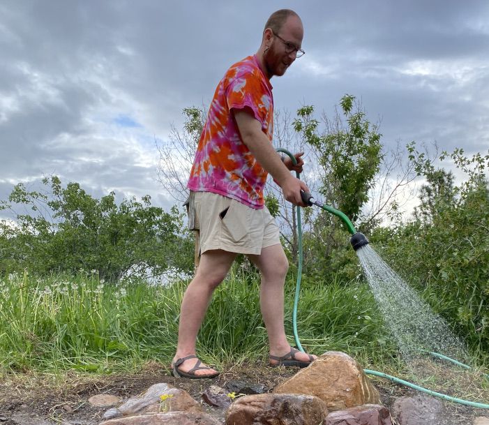 kaleb watering rock garden