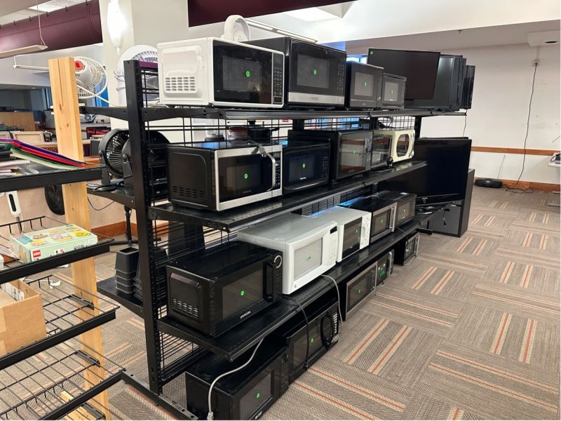 row of microwaves on display