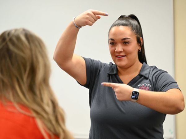 Athletic Training student Alicia Camel works with the Lady Griz basketball team