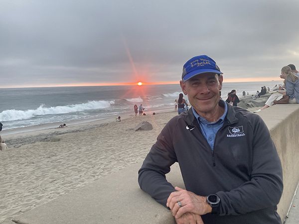 Brian Fruit at the beach as the sun sets in the distance