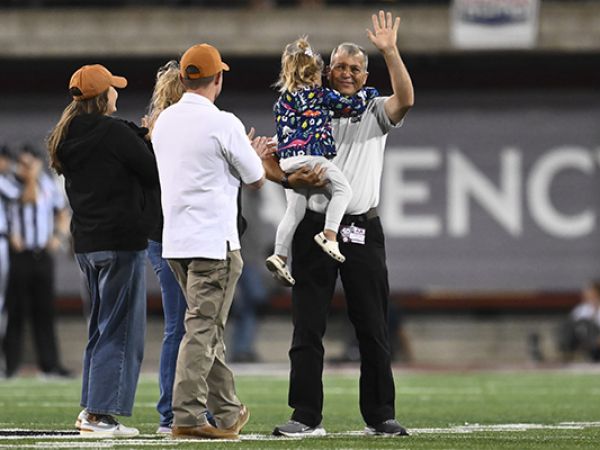 Chuck Maes with his family on the Griz Football field. 