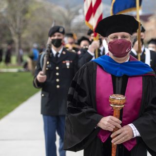 Faculty Senate Chair Chris Palmer with Graduation Mace