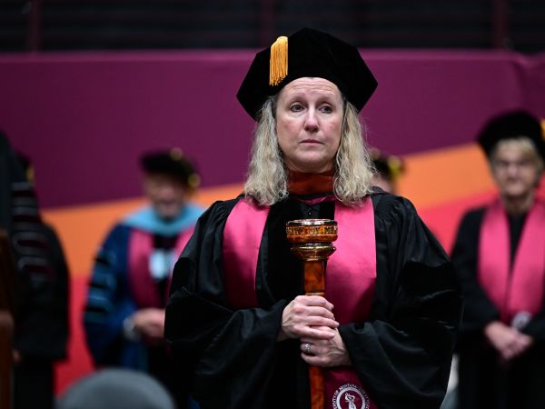 Faculty Senate Chair Valerie Moody with Graduation Mace