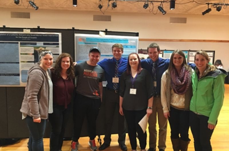 CRESP Lab Members standing in front of a poster at a conference