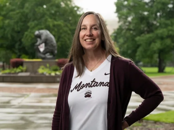 Director of Admissions Kelly Nolin smiles for a portrait in front of the Grizzly Bear statue on the University of Montana campus.