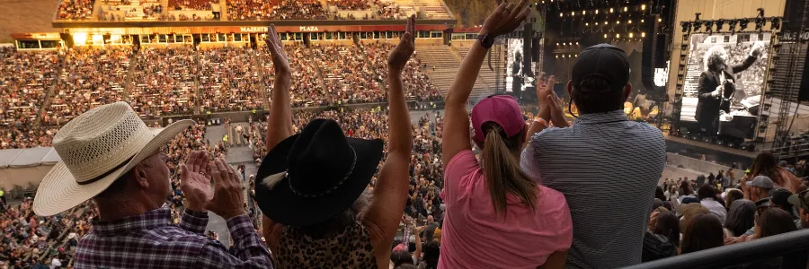 A stadium crowd cheers at a Tyler Childers concert