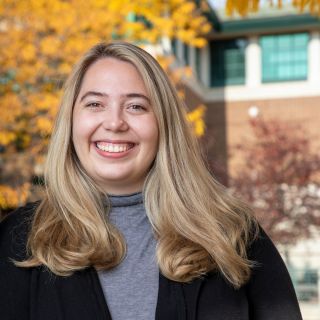 Image of Sophie smiling because she's ready to help plan your visit