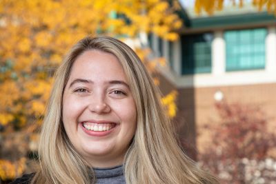 Image of Sophie smiling because she's ready to help plan your visit
