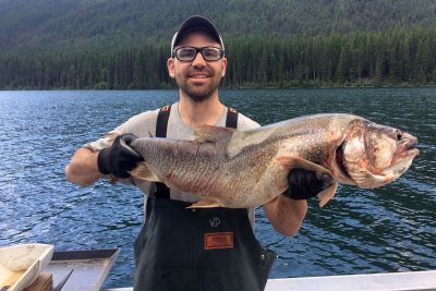 Vin D’Angelo, a USGS fisheries biologist, holds up a nonnative lake trout that was caught recently in Glacier National Park’s Logging Lake.