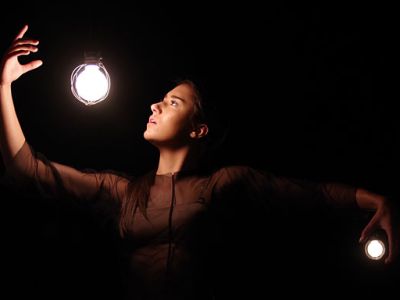 An artistic picture of a dancer with light bulbs