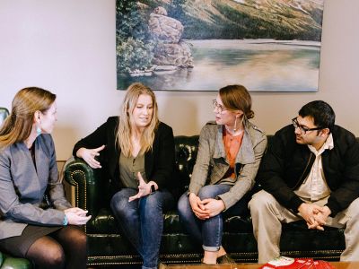 Photo of students meeting with faculty member.