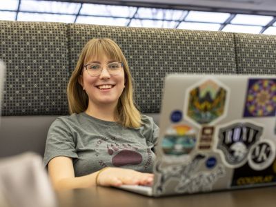 Photo of student sitting in front of laptop. 