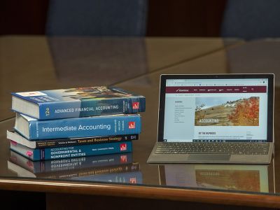 Photo of accounting books and laptop