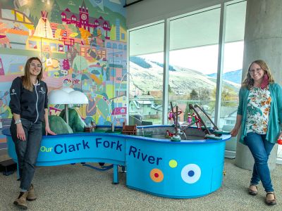 SpectrUM Director Jessie Herbert-Meny (right) and AmericCorp leader Brooke Carey reveal part of the discovery area’s new digs within the Missoula Public Library building.