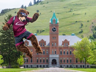 A picture of Monte clicking his heels on happiness on the UM Oval. 