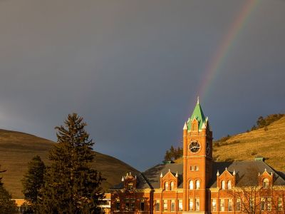 A rainbow reaches down to Main Hall.