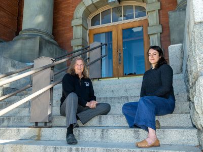 A picture of Mary-Ann Sontag Bowman and Kaya Juda-Nelson posing on the steps of Jeannette Rankin Hall.
