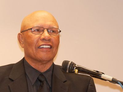 A picture of Ulysses S. Doss speaking at a podium.
