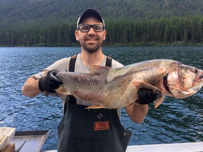 Vin D’Angelo, a USGS fisheries biologist, holds up a nonnative lake trout that was caught recently in Glacier National Park’s Logging Lake.