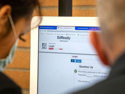 Two adult learners look at the EdReady website.